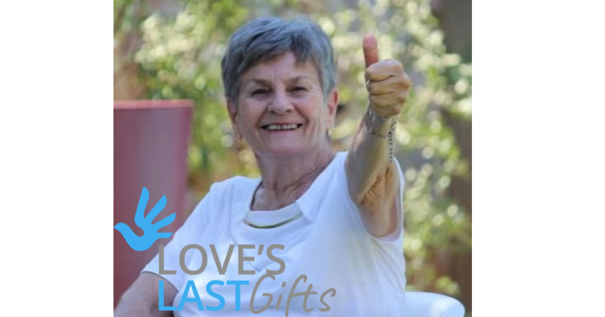 Karin Petersen’s mother smiling and giving a thumbs up in her garden, with the Love’s Last Gifts logo