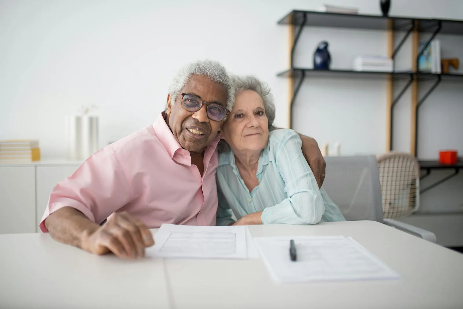 An older couple looking through paperwork together.